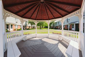 a gazebo with a wooden roof and white benches at Encore 99, East Haven, 06512
